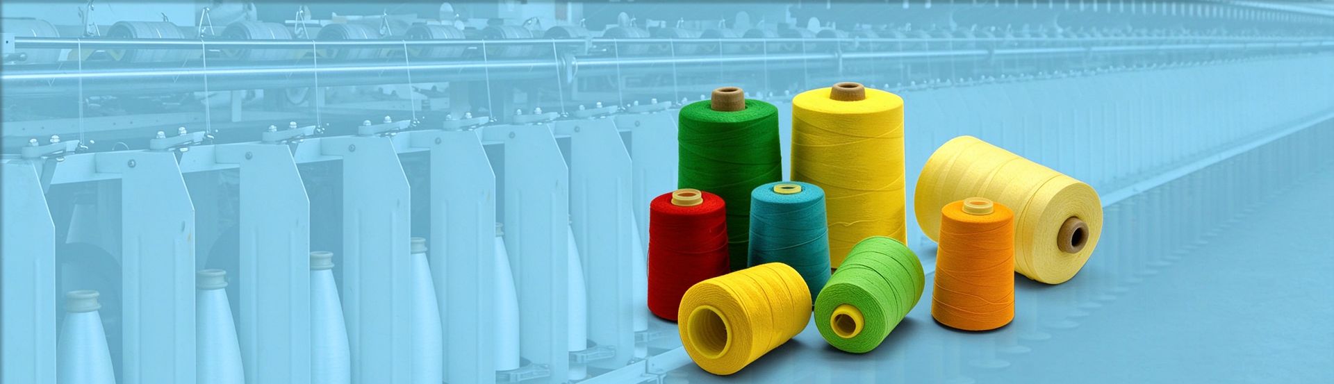 Colorful polyester sewing thread cones in front of spinning machines